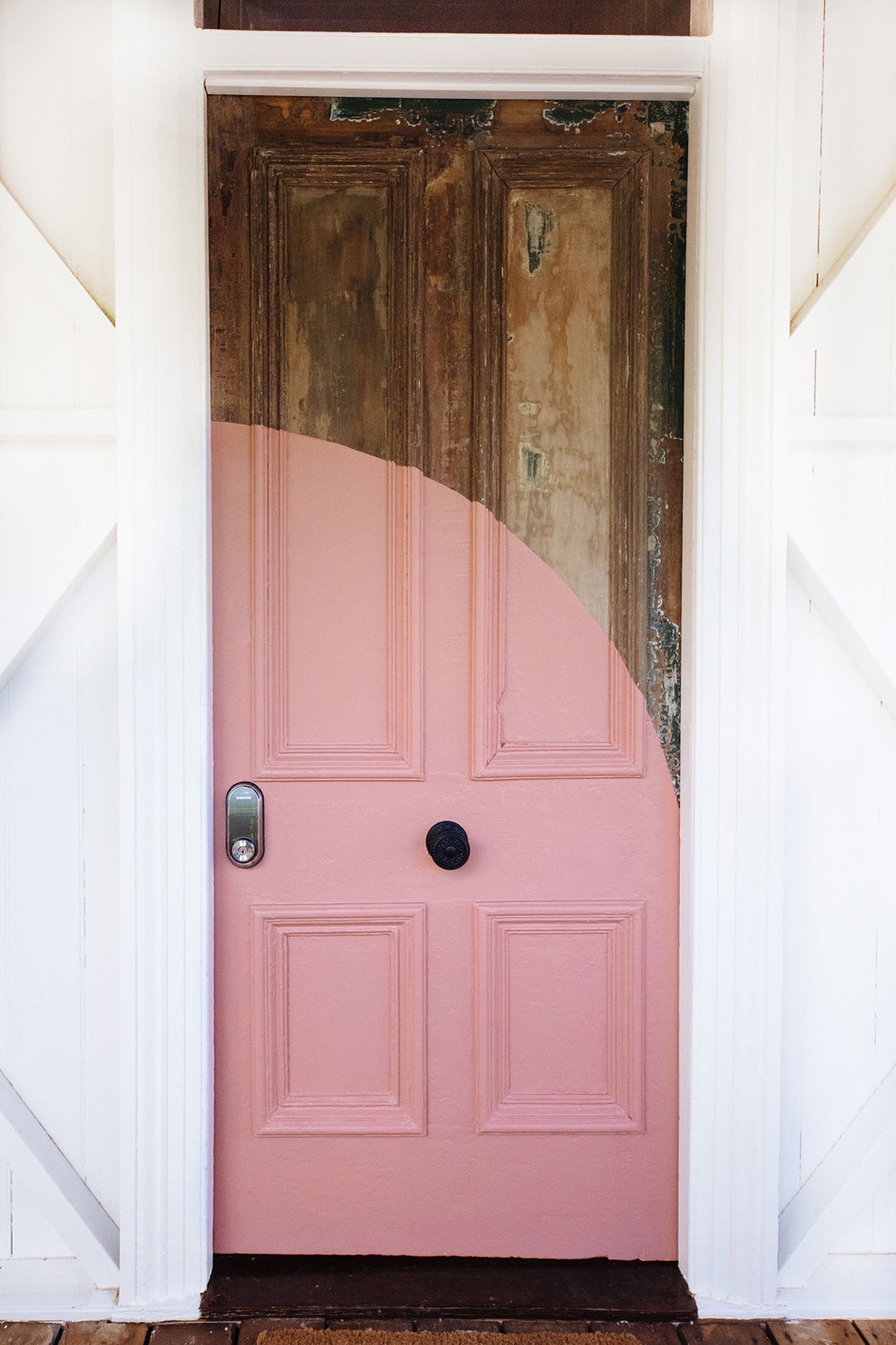 pink arc across wood front door