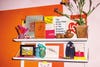 Bookshelf on an orange and pink wall