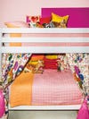 white bunk bed bed with pink and orange bedding