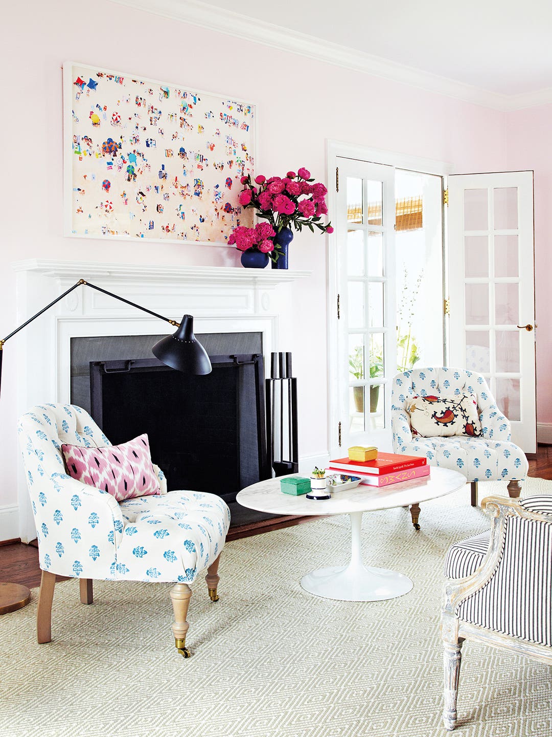 Living room with pink walls and patterned chairs
