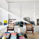 White living room with X-beam crossing in front of art