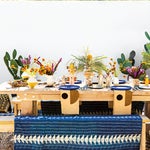 plywood dining table outdoors with block-printed blanket