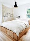 Block wood bed with white bedding