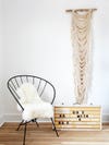 Chair with sheepskin hanging next to a vintage sign