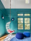 white swing chair in blue room