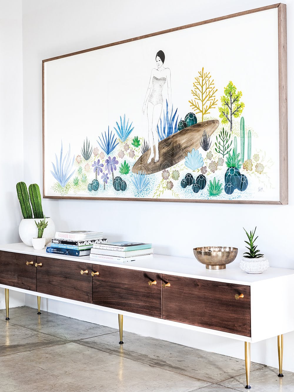 artwork of woman in nature above credenza