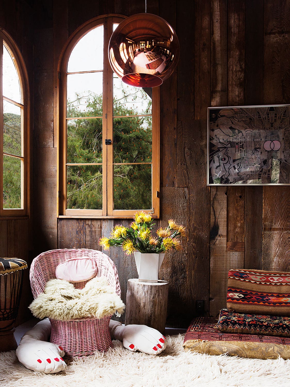 wood paneled room with pink wicker chair