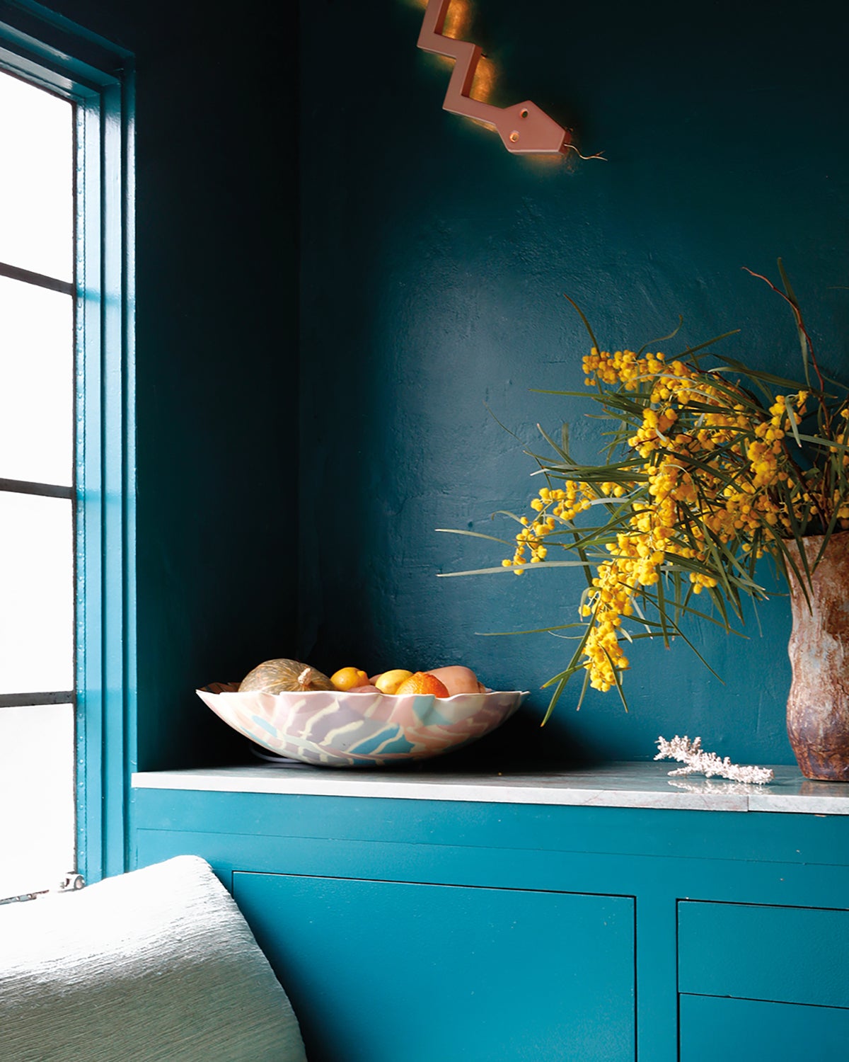 teal kitchen corner with matching cabinetry