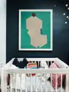 Nursery with black painted walls and artwork with green background.