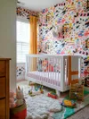 Nursery with paintbrush stroke wallpaper and white crib.