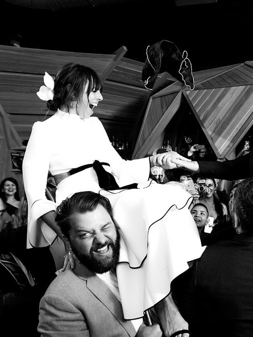 bride and groom lifted up at wedding