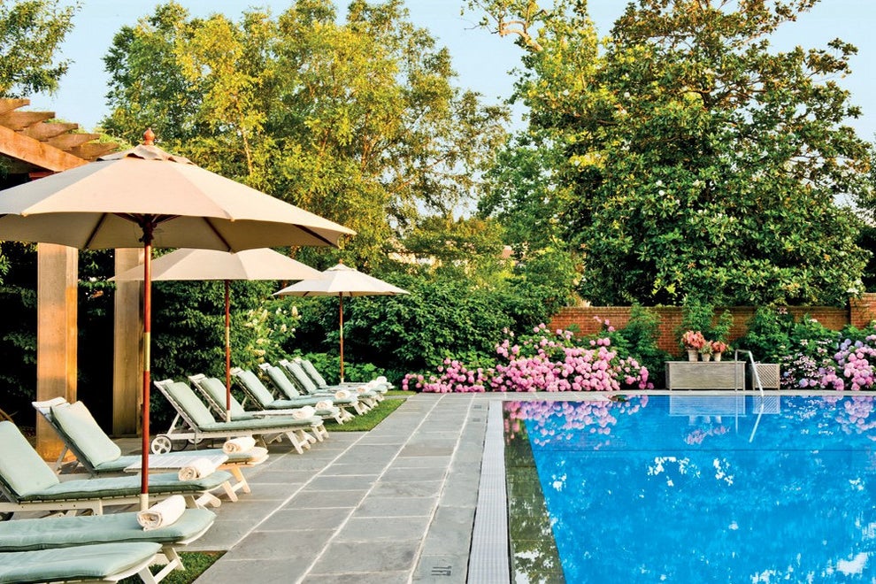 lounge chairs alongside an outdoor pool