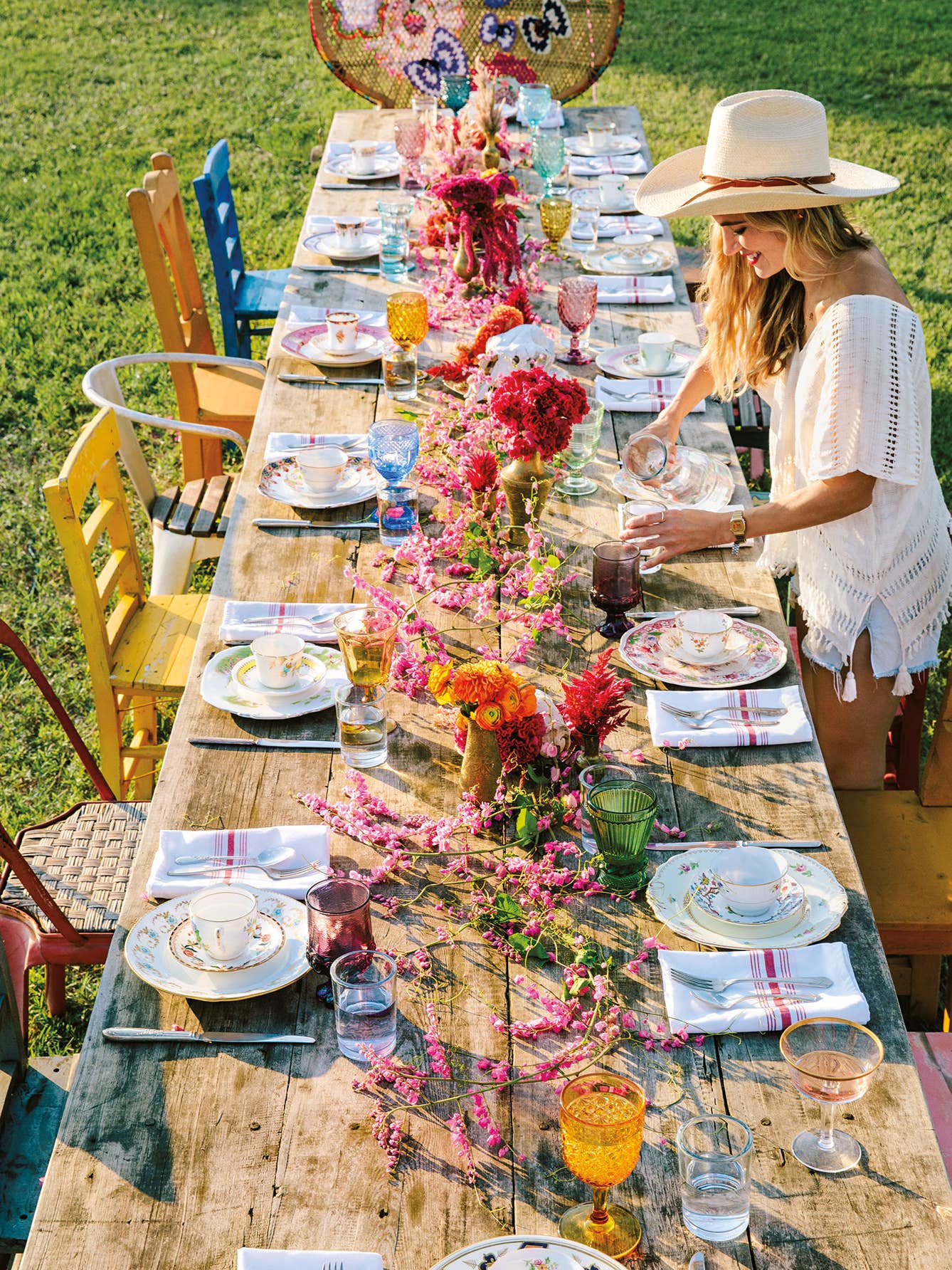 long farmhouse table with colorful floral centerpiece