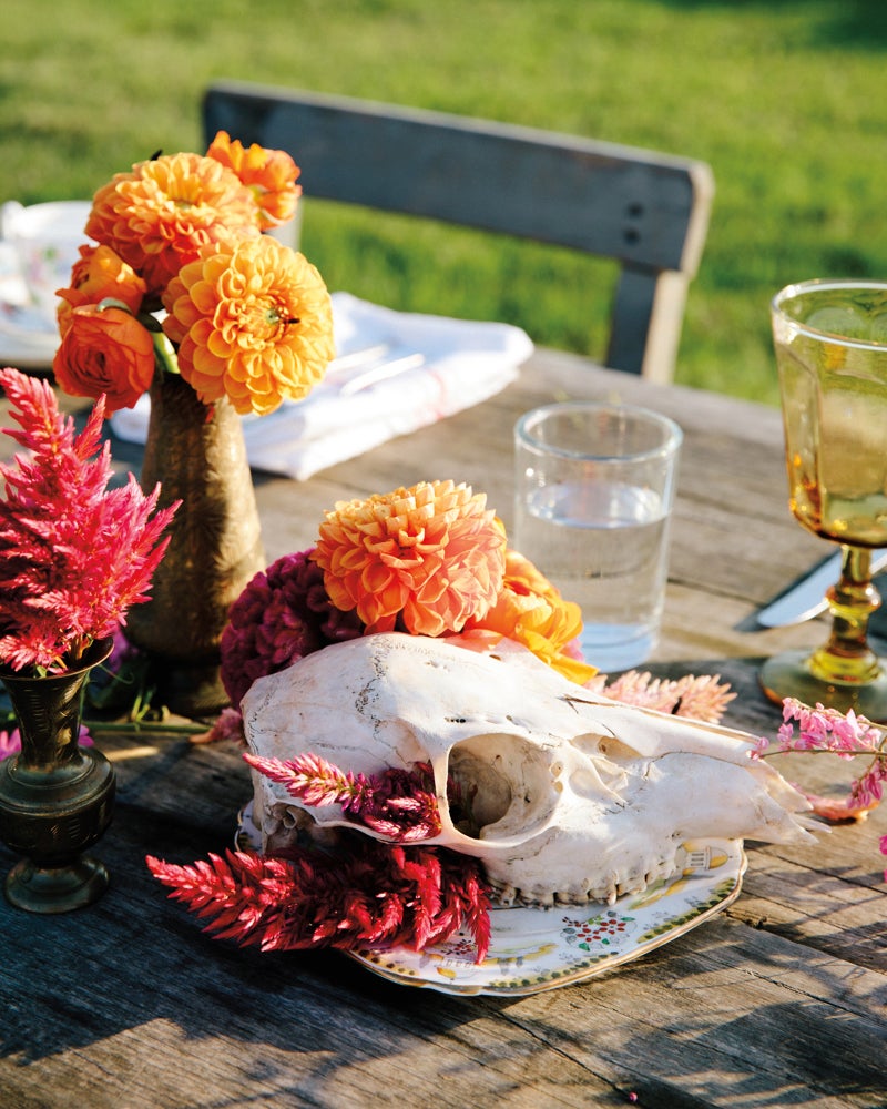 old animal skull centerpiece with sunset-colored flowers