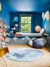 By's bedroom with dark blue outer space mural covering all walls and ceiling.