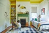 Kids' room with yellow ceiling and black-and-white checkered rug. 