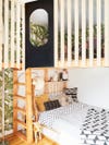 Kid's room with lofted bed with ladder and wood slats.