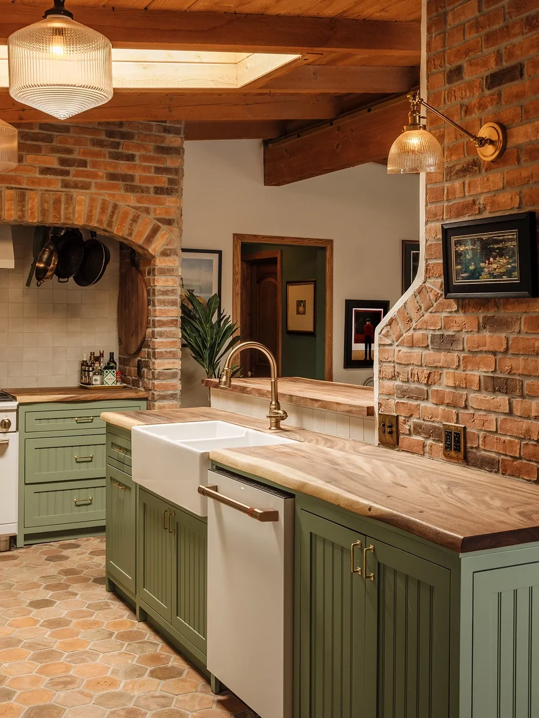 Brick kitchen with sage green cabinets.