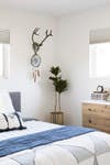 Bedding, bed, planter and dresser, West Elm; Pillow, a. Naber Design; Antler, vintage<br />
