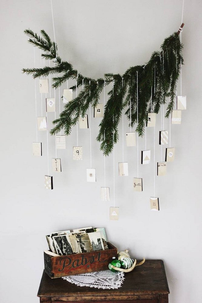 scandinavian christmas decor white room with branches and advent calendar
