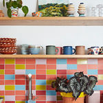 colorful kitchen backsplash with coffee mugs on open shelves