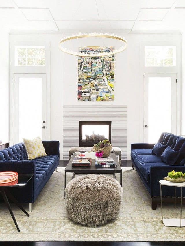 white living room with navy couches