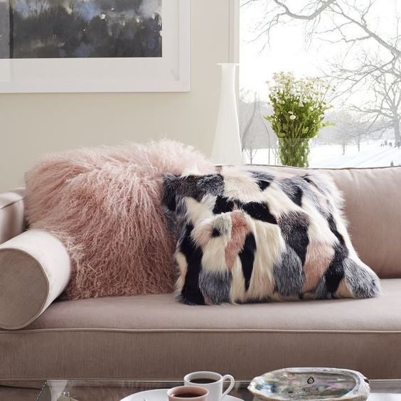 pink couch with fur pillow