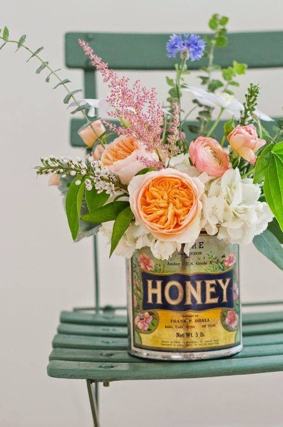 Easy Spring Centerpieces honey tin with flowers centerpiece
