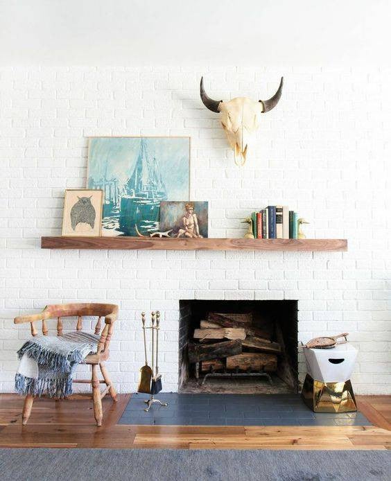 mantel decorating ideas for spring colorful art and books on a mantel