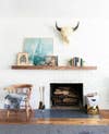 mantel decorating ideas for spring colorful art and books on a mantel