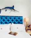pillow shapes blue tufted headboard with white bedding