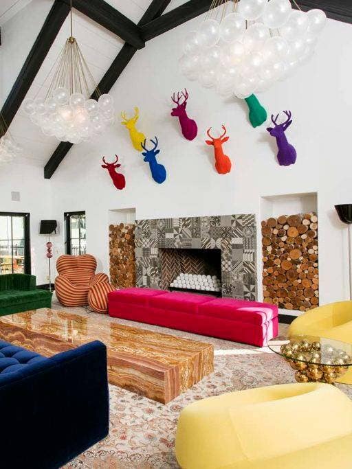 newport beach home white living room with colorful deer heads