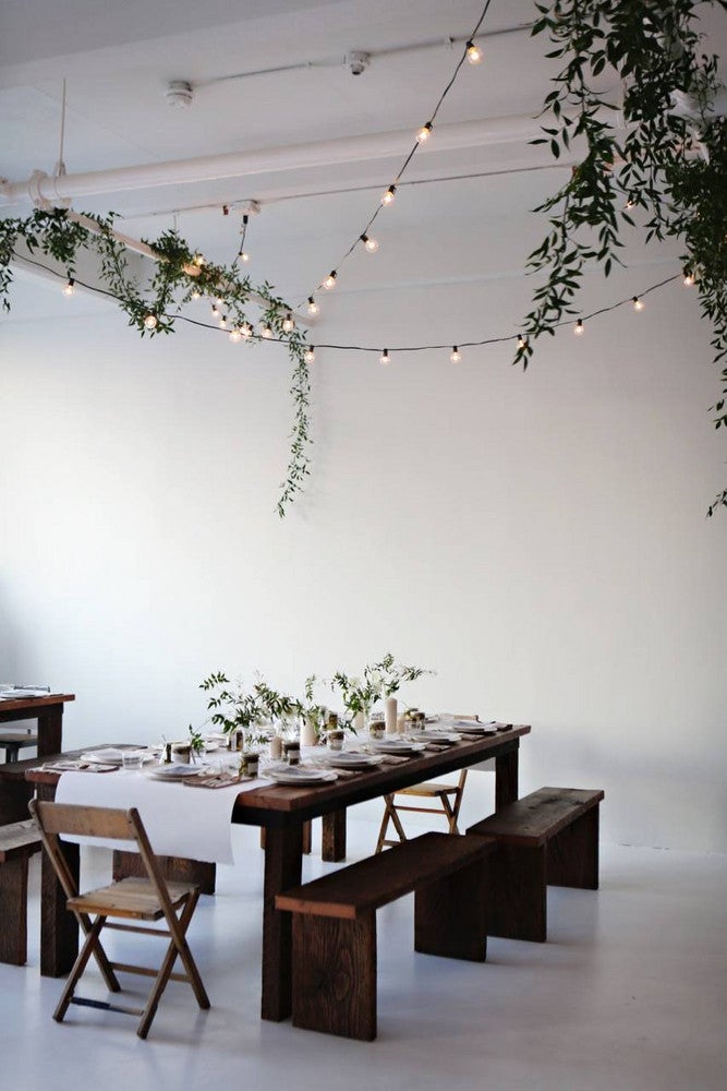 small space dinner party white room with wood table and benches