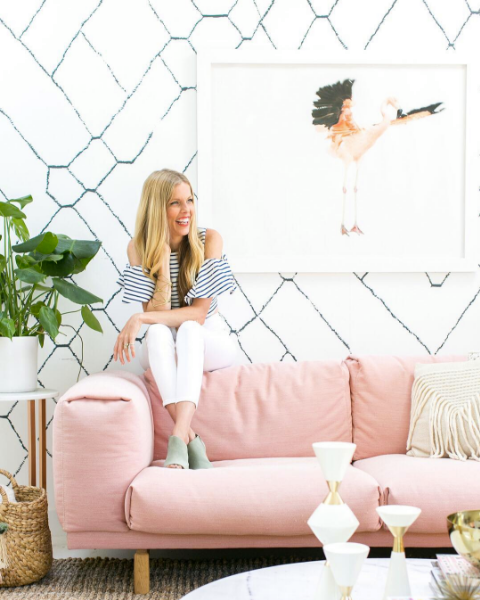 domino magazine pink sofa and white and black wallpaper