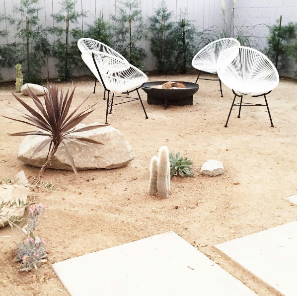 domino magazine sand backyard with acapulco chairs