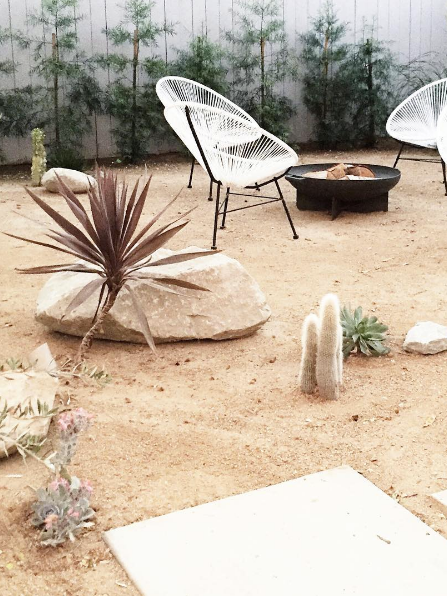 domino magazine sand backyard with acapulco chairs
