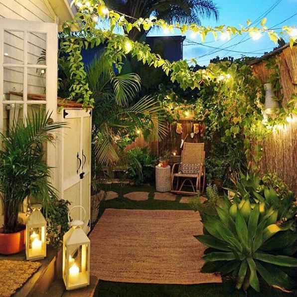 domino magazine patio with bistro lights and vines