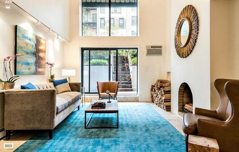 brandon humans of new york high ceiling living room with blue rug