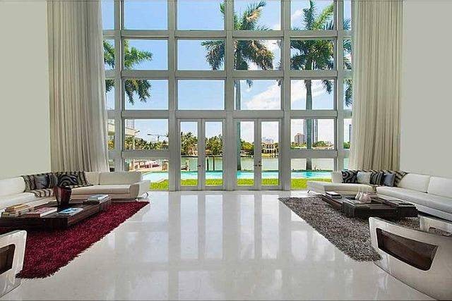 lil wayne house white high ceiling living room with floor to ceiling windows