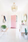 all white interiors white entryway with pink door