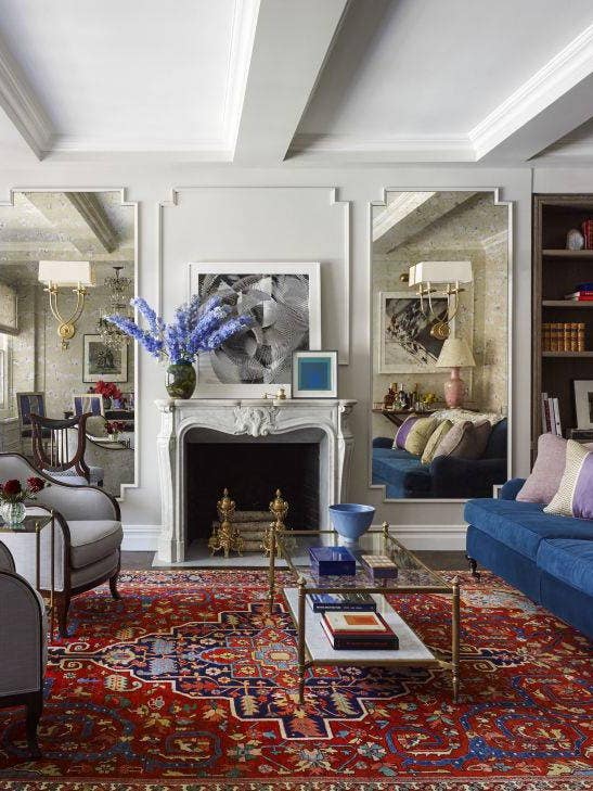 emmy rossum white living room with red and blue rug