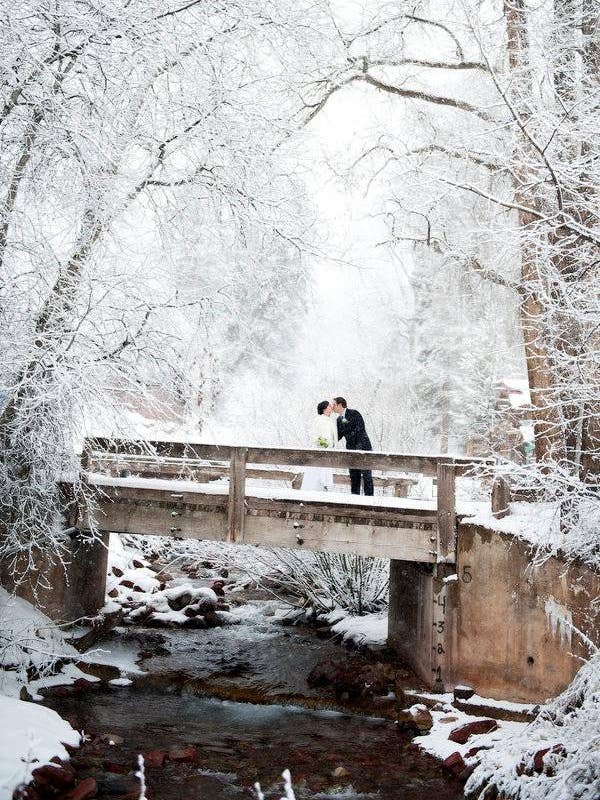 winter wedding ideas wedding photo in the snow on a bridge
