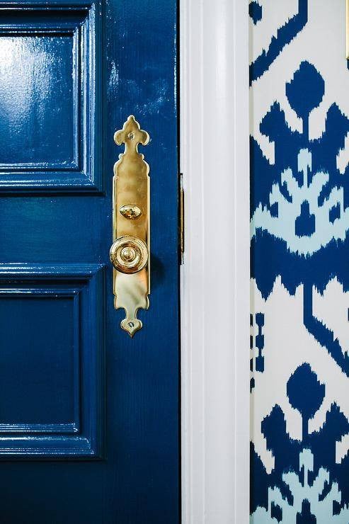 painted door brass hardware on blue door