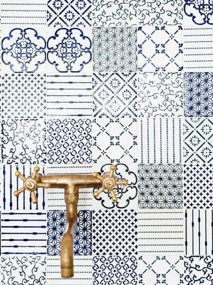 kitchen cleaning tips  blue and white backsplash with brass fixtures