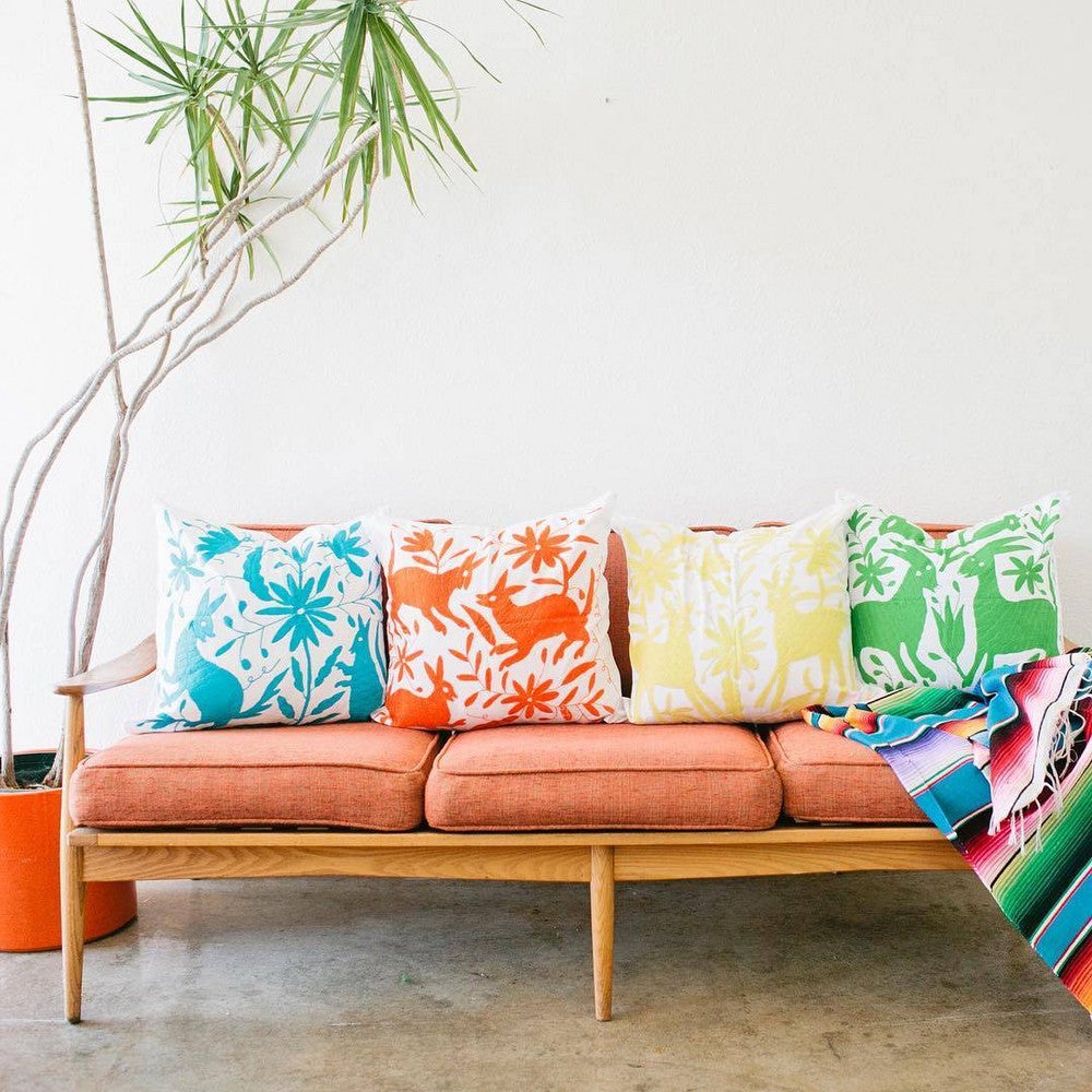 otomi print otomi pillows on orange sofa
