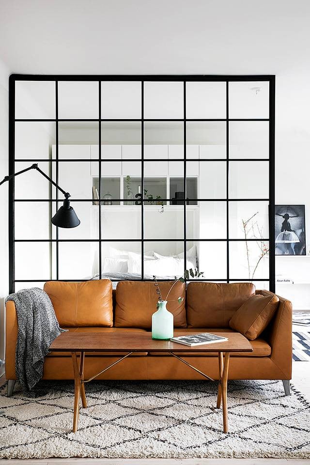 glass partitions black paned glass partition behind leather sofa