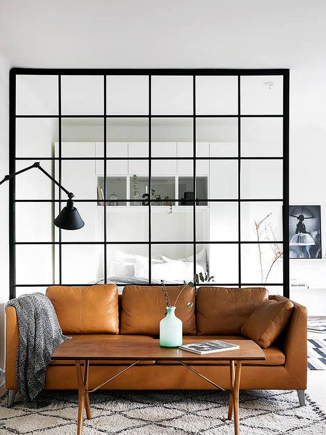 glass partitions black paned glass partition behind leather sofa