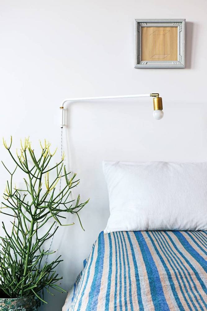 nail color trends white wall bedroom with blue and white striped blanket