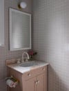 Bathroom with grid wall and dusty pink vanity