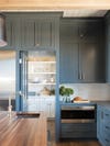 Blue kitchen with white hidden pantry